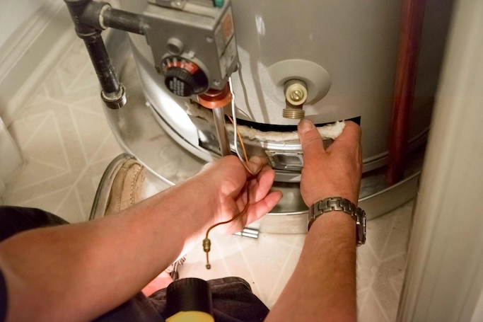 Plumber fixing a water heater, Plumbing services in Winston-Salem, NC