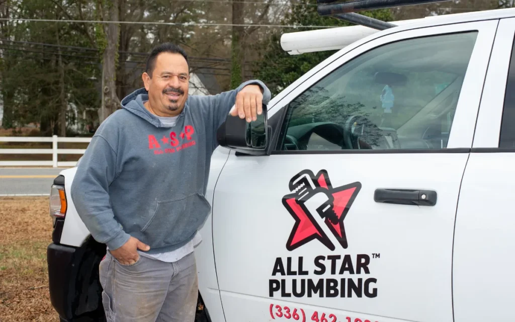 Local All Star Plumbing plumber beside a company truck serving Winston-Salem NC