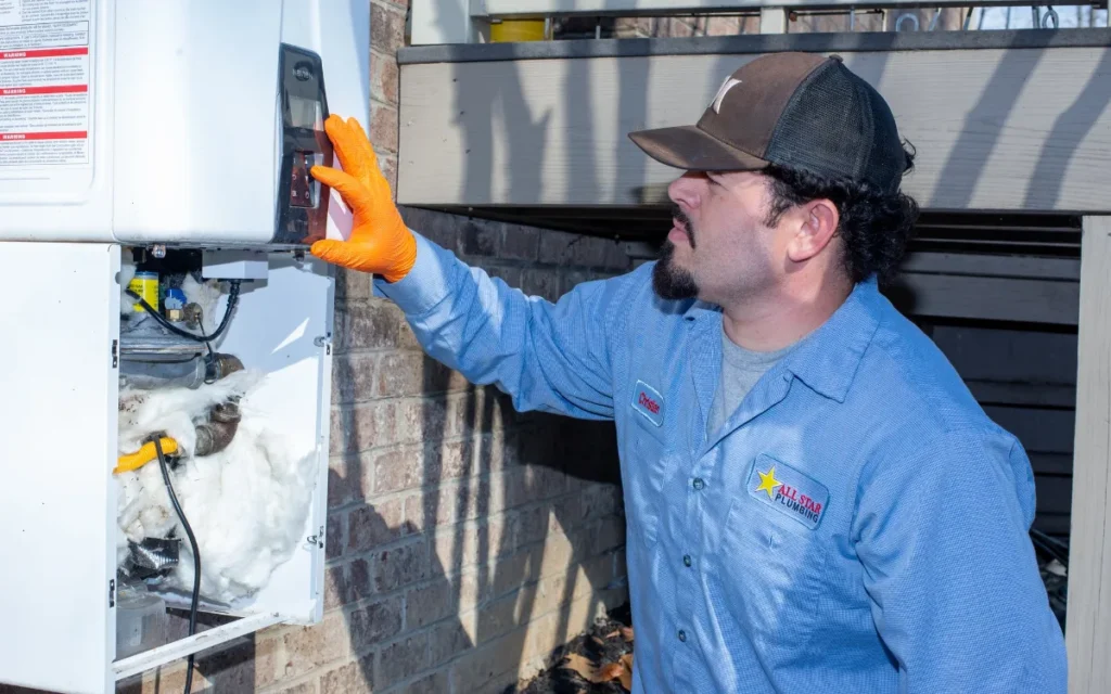 All Star Plumbing technician performing annual water heater maintenance at a High Point NC home